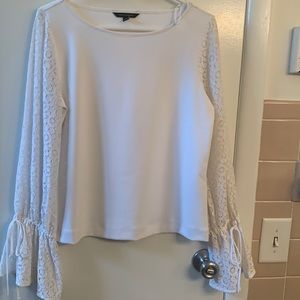 Beautiful white blouse with lacy sleeves with ties